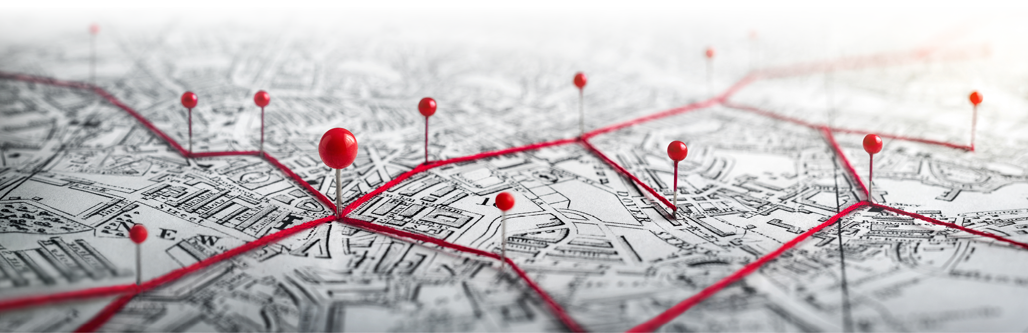 Routes with red pins on a city map. Concept on the adventure, discovery, navigation, communication, logistics, geography, transport and travel topics.